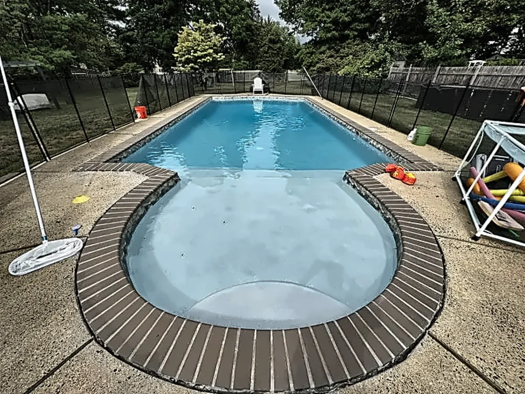 In-ground pool awaiting seasonal opening and cleaning