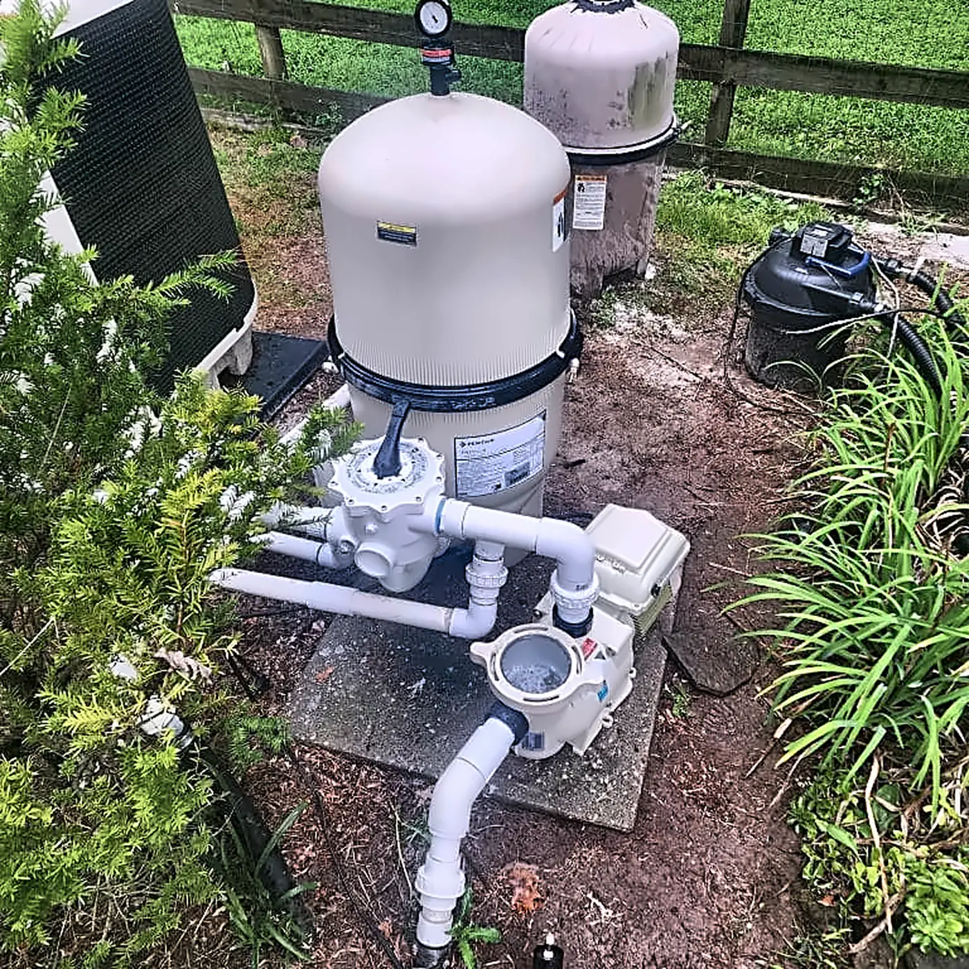 Home 8 Pool filter, pump, and plumbing equipment beside a residential pool